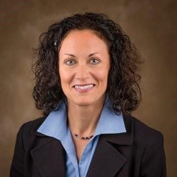 Carol Ferrari, VP of Product Marketing at Salary.com seen posing for a photo in a formal office outfit